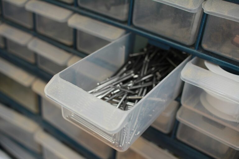 Wall of clear plastic parts drawers with one drawer pulled out