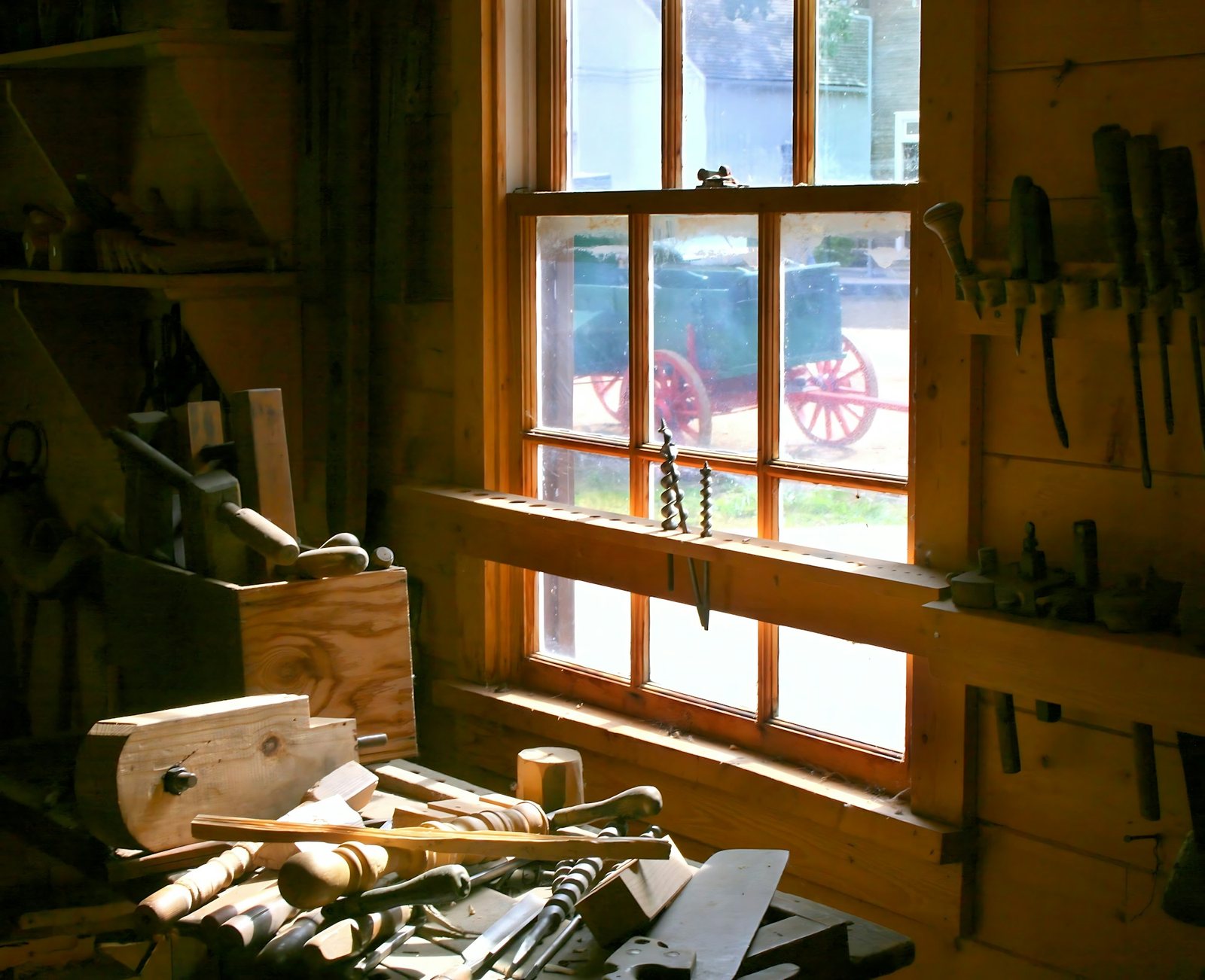 Old woodworking shop with hand tools on a bench by a window