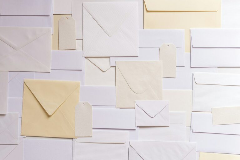 Flat lay of blank cream and white envelopes and paper tags