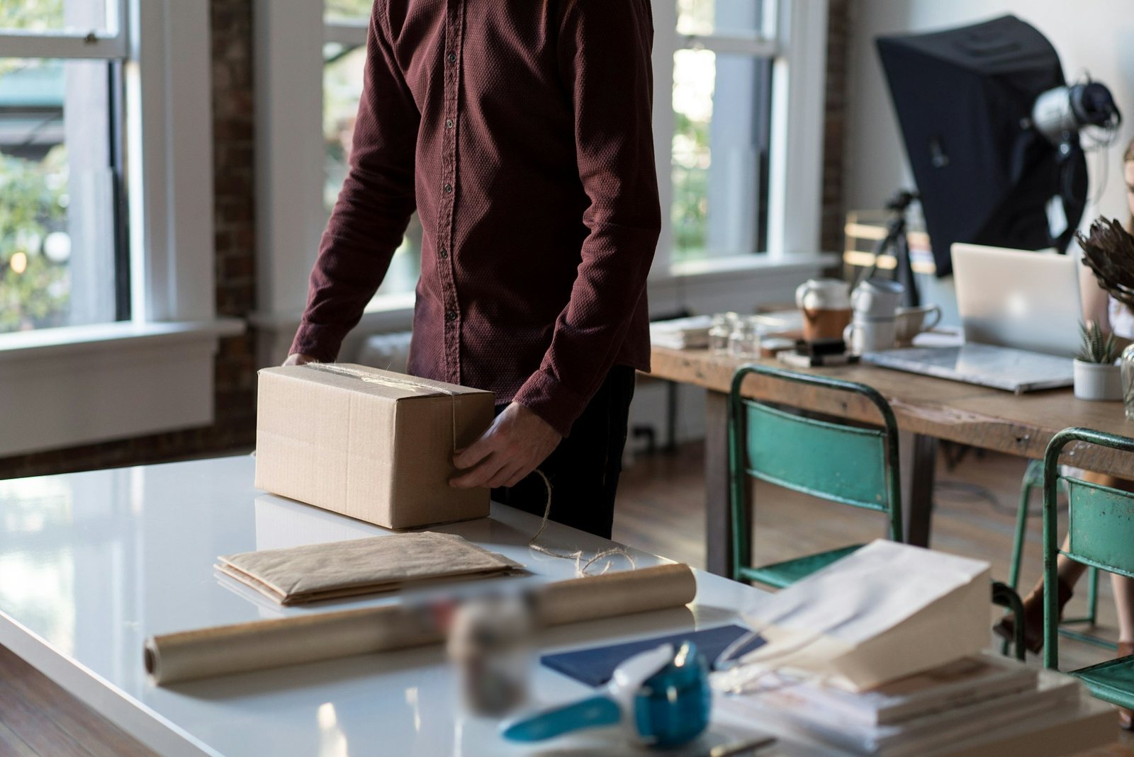 Packing table with a parcel, kraft paper and twine