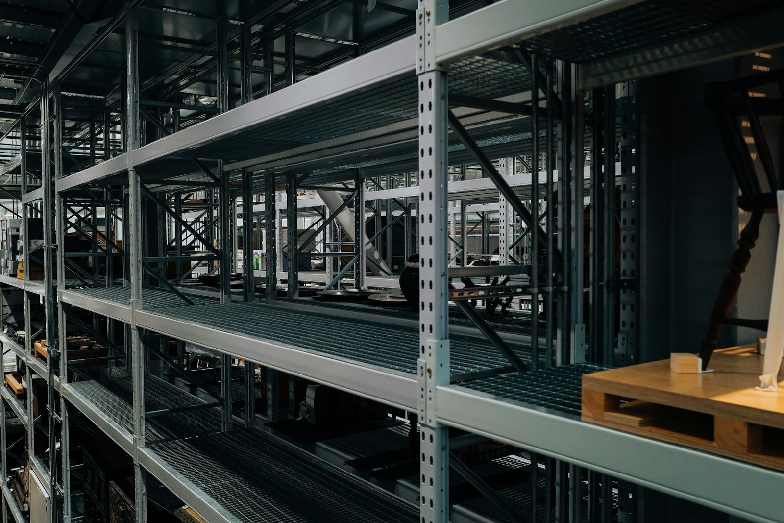 Tall stockroom shelving with mostly empty shelves
