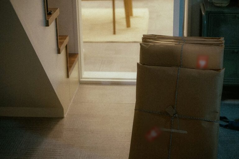 Paper-wrapped parcels tied with twine waiting by a doorway