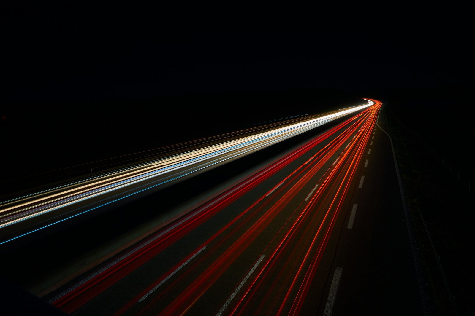 Long-exposure light trails on a highway at night
