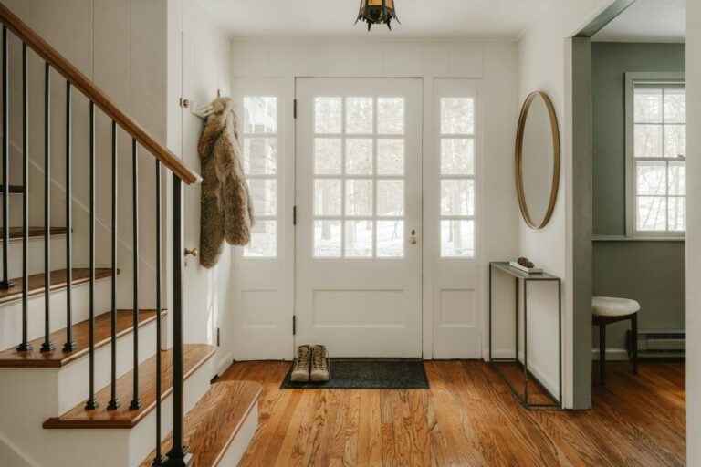 Bright entrance hall with a glazed front door and a doormat